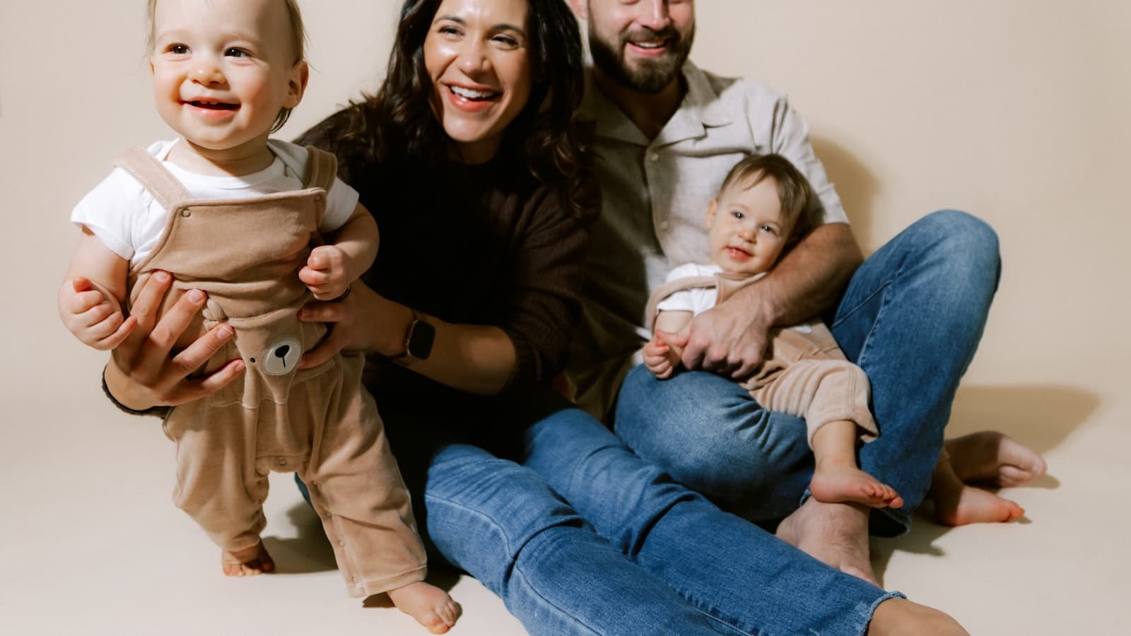 Relaxed family laughing together during a natural studio portrait session