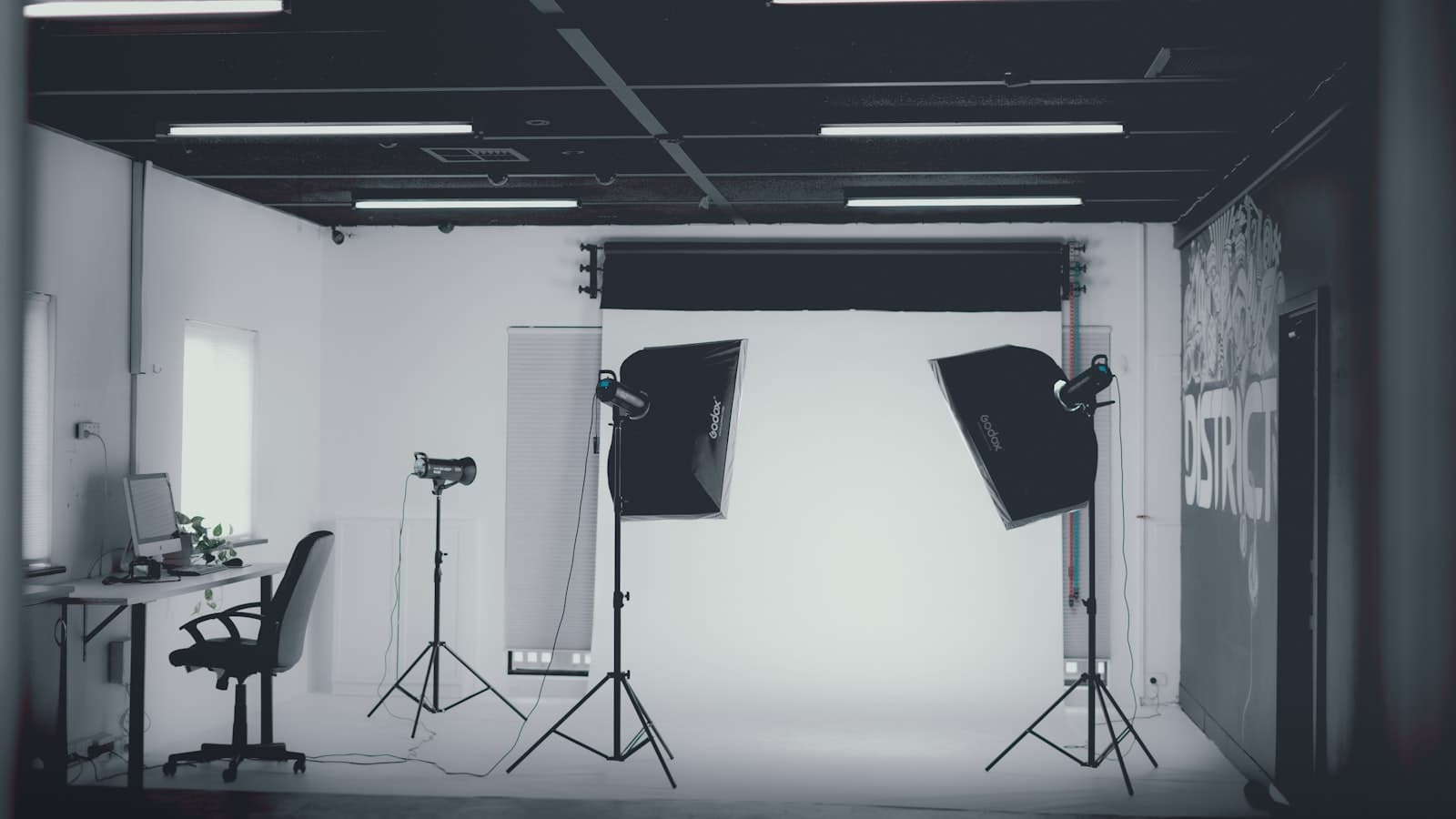 Photography studio with strobe lights and softboxes set up for a shoot