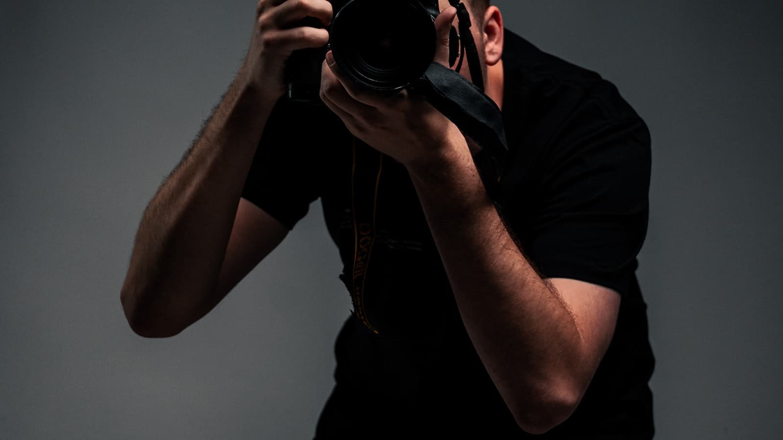 Photographer holding a camera in a professional studio