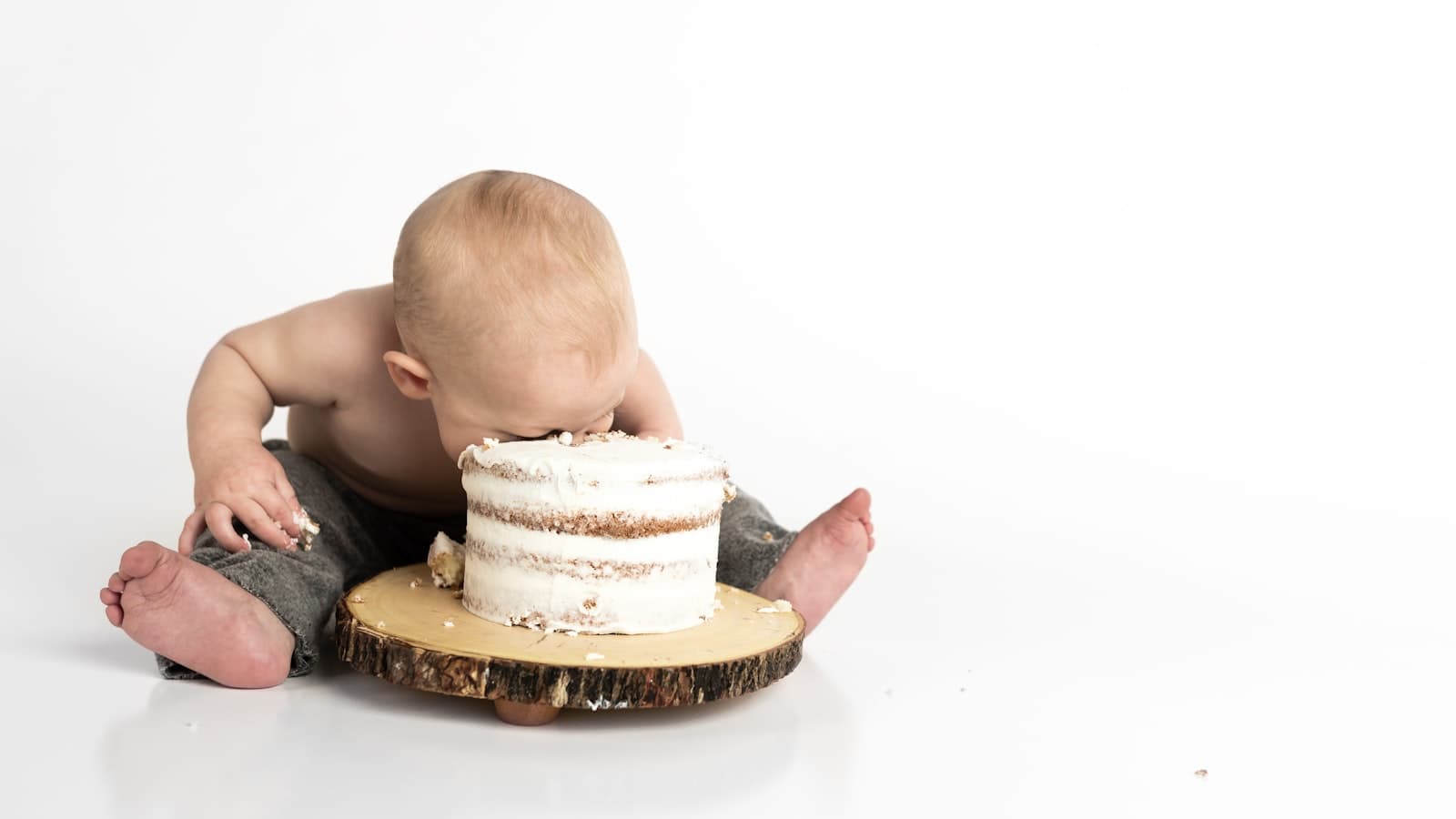 First-birthday baby with cake during a cake smash session
