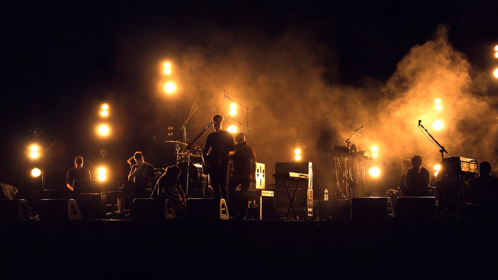 Musician performing under stage lighting in a studio environment