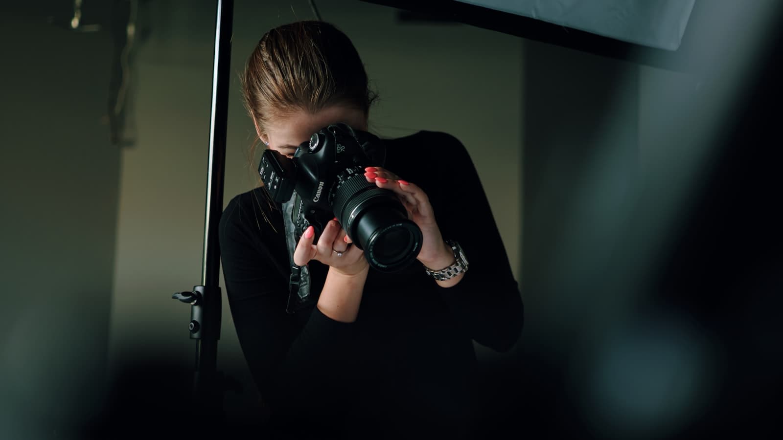 Photographer reviewing camera with workshop attendees