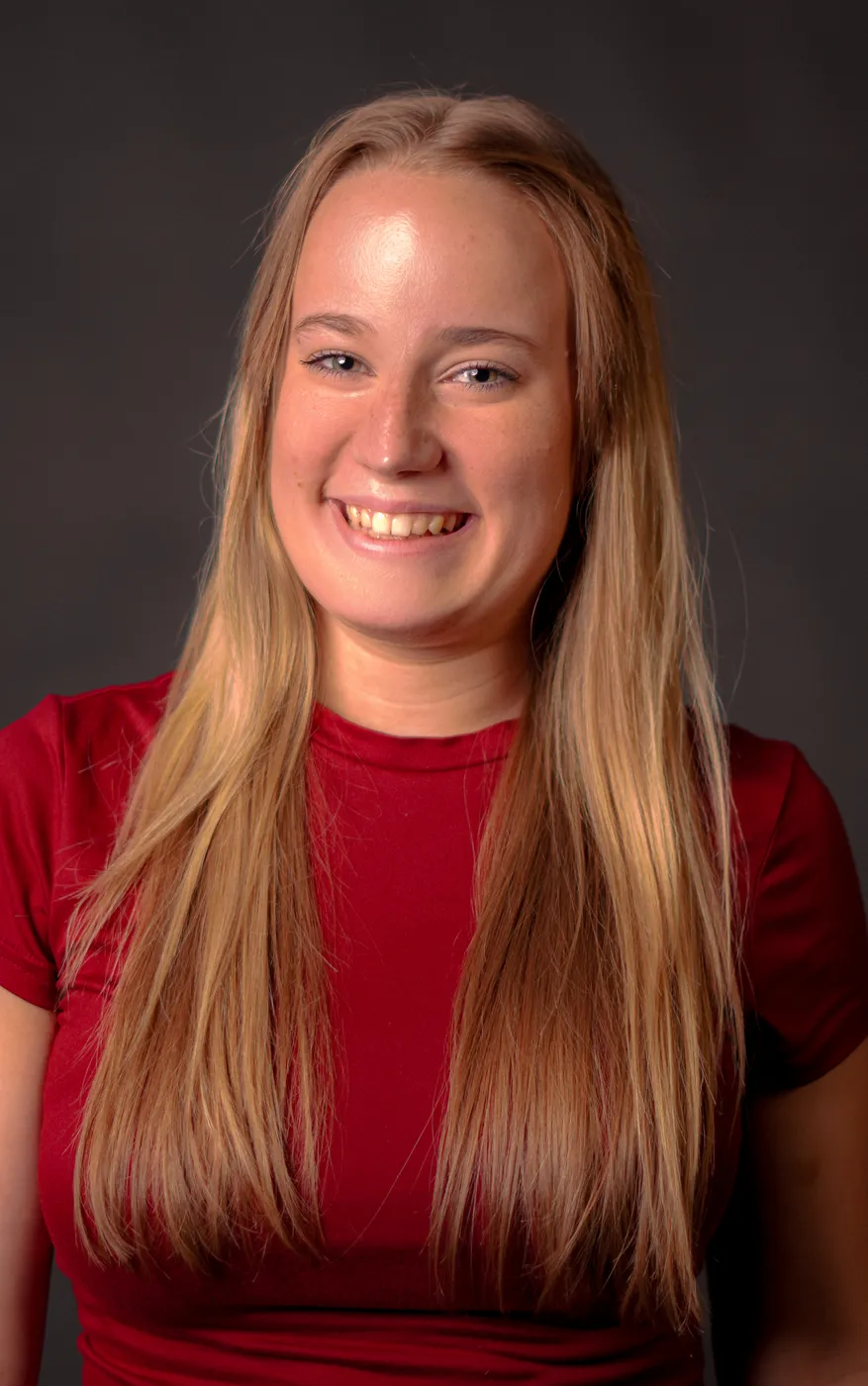 A smiling young woman in a studio portrait