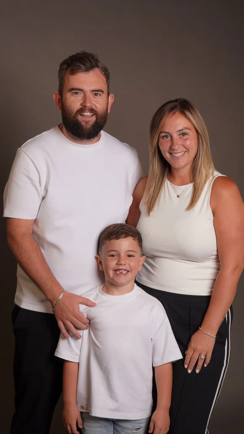 A family of three in matching white tees