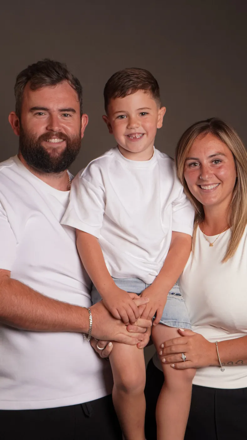 A family of three in white tees