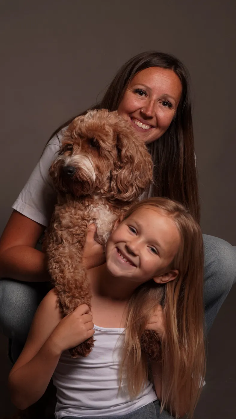 A woman and girl with their cockapoo